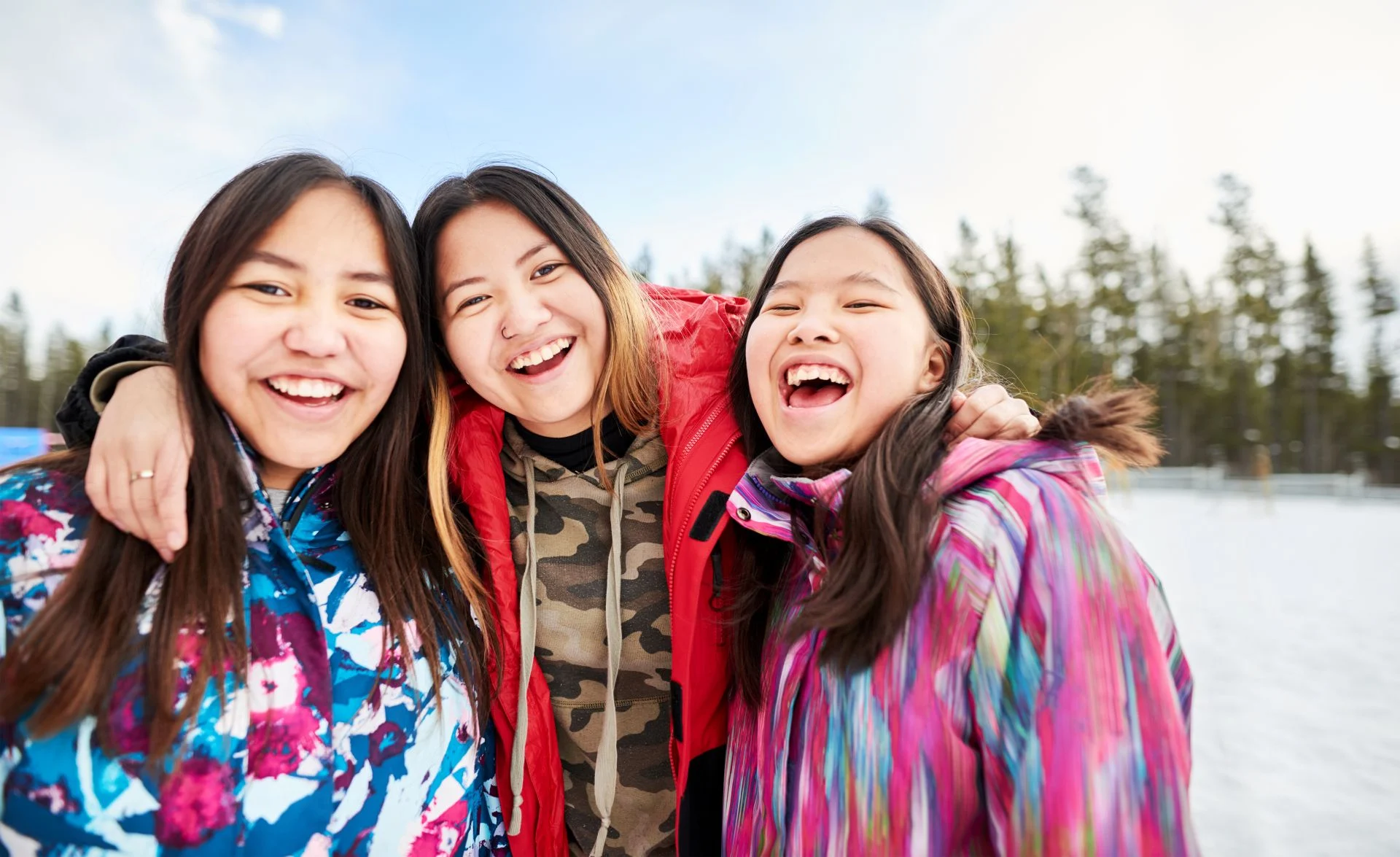 Group of happy children laughing together outdoors in winter