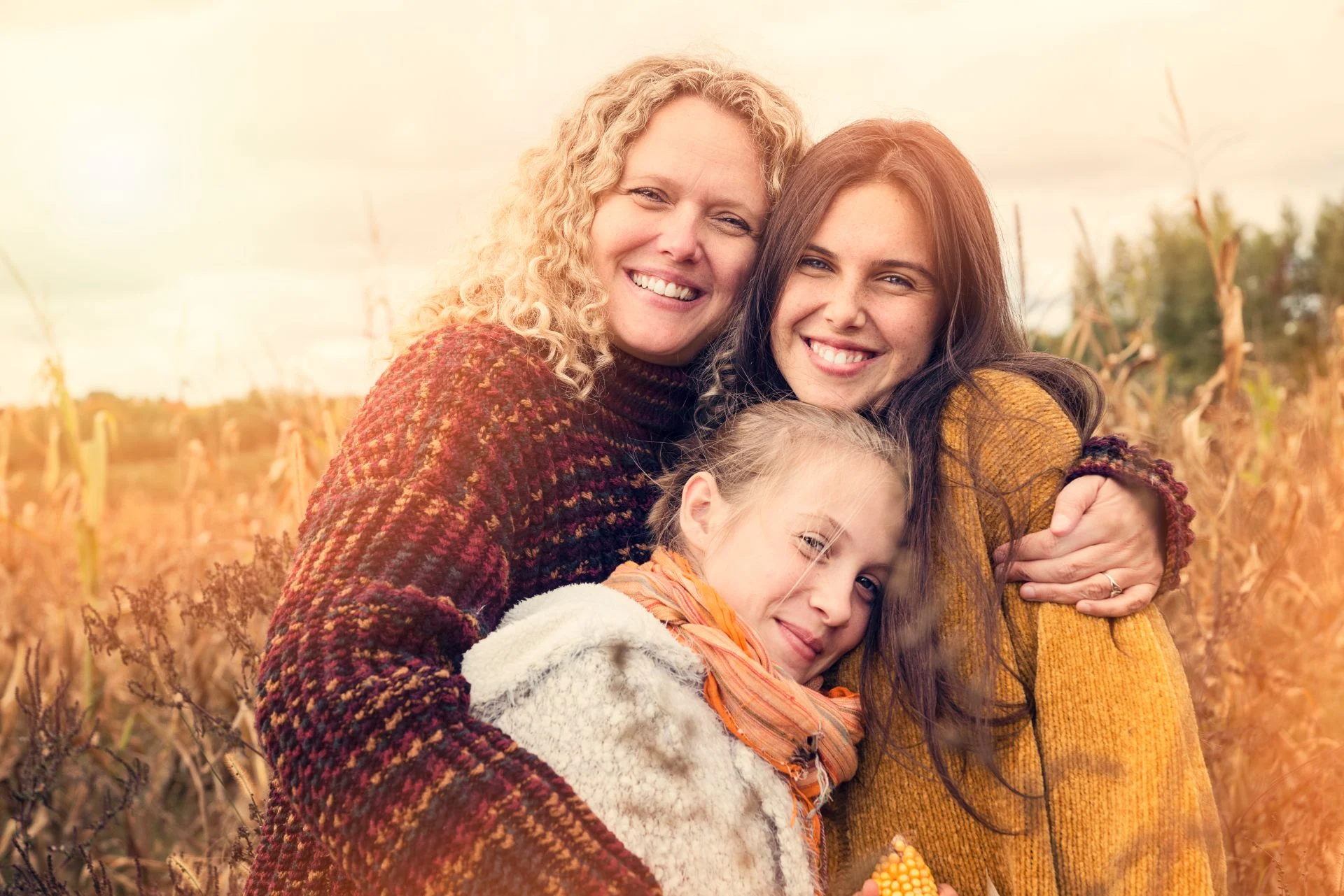Mother and daughter sharing a warm hug during autumn outdoors