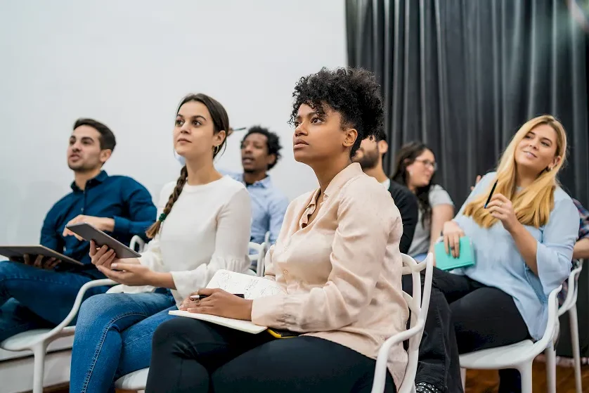 A group of people listening to a training lecture.